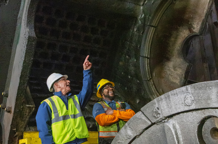 Employees reviewing operations inside recycling facility