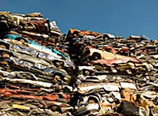 Stacked crushed cars at recycling facility
