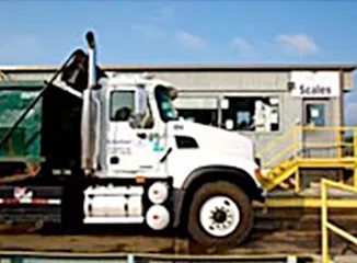 Scrap collection truck at facility scale house