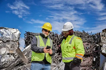 Supervisors reviewing operations at scrap yard
