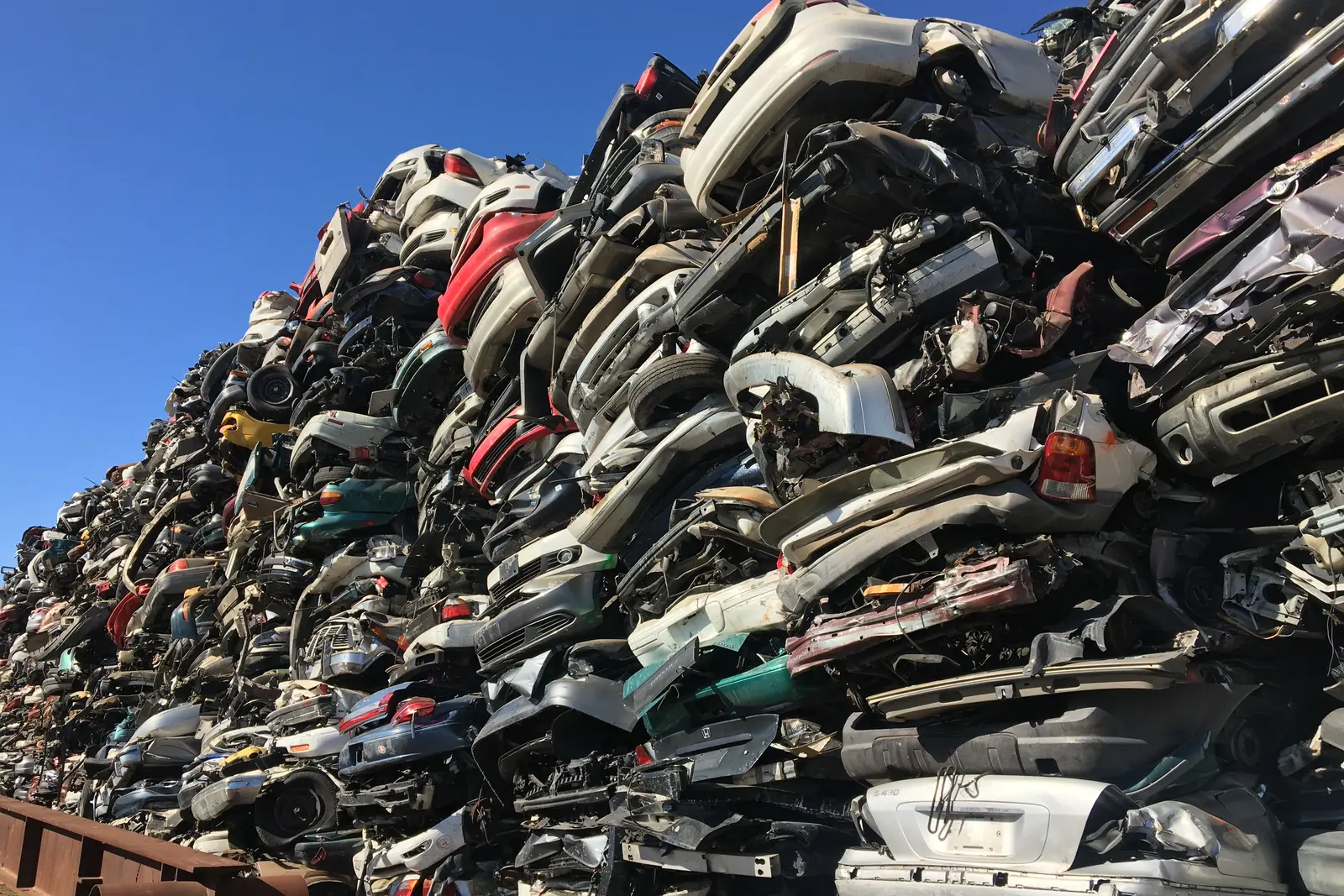 Scrap vehicles processed at a metal recycling yard
