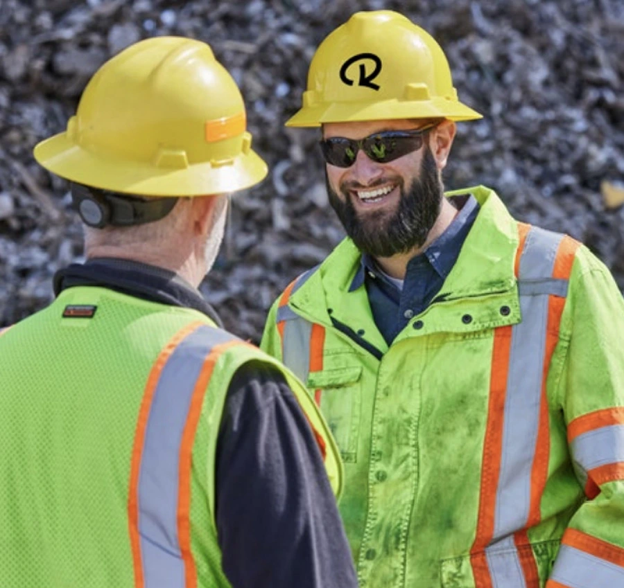 Radius Recycling professionals discussing safe and responsible operation