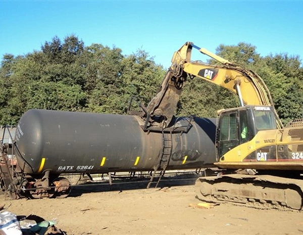 Railcar Dismantling and Asset Recovery Excavator dismantling railcar for recycling recovery