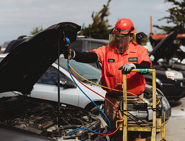 Certified Destruction and Automotive Recycling Services Technician performing certified vehicle parts recycling service
