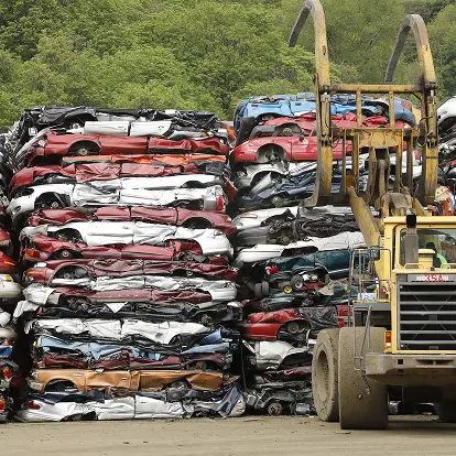 Stacked crushed scrap vehicles prepared for recycling