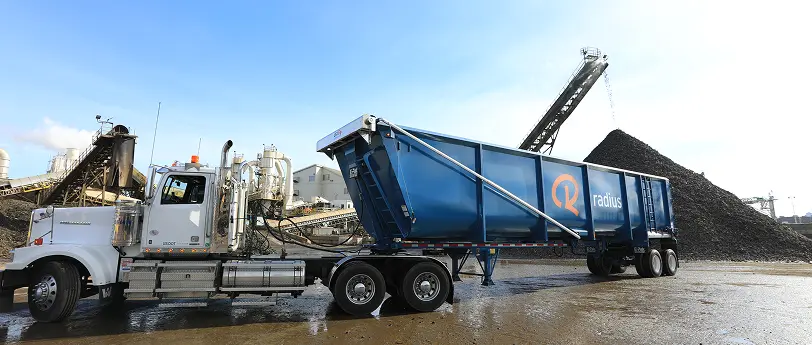 Scrap metal transportation using roll-off trailer